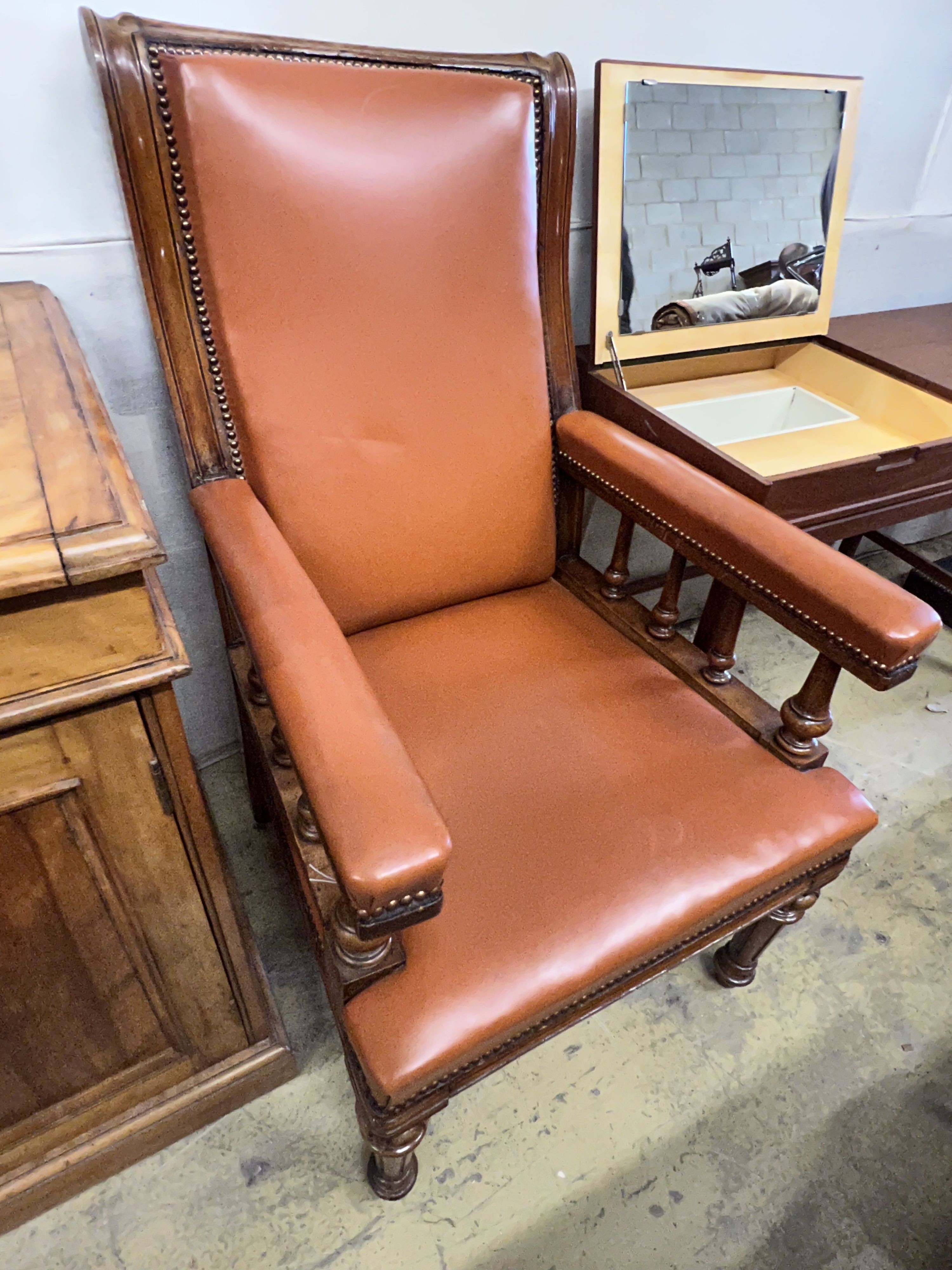 A late Victorian oak and leather library armchair, width 62cm depth 76cm height 110cm